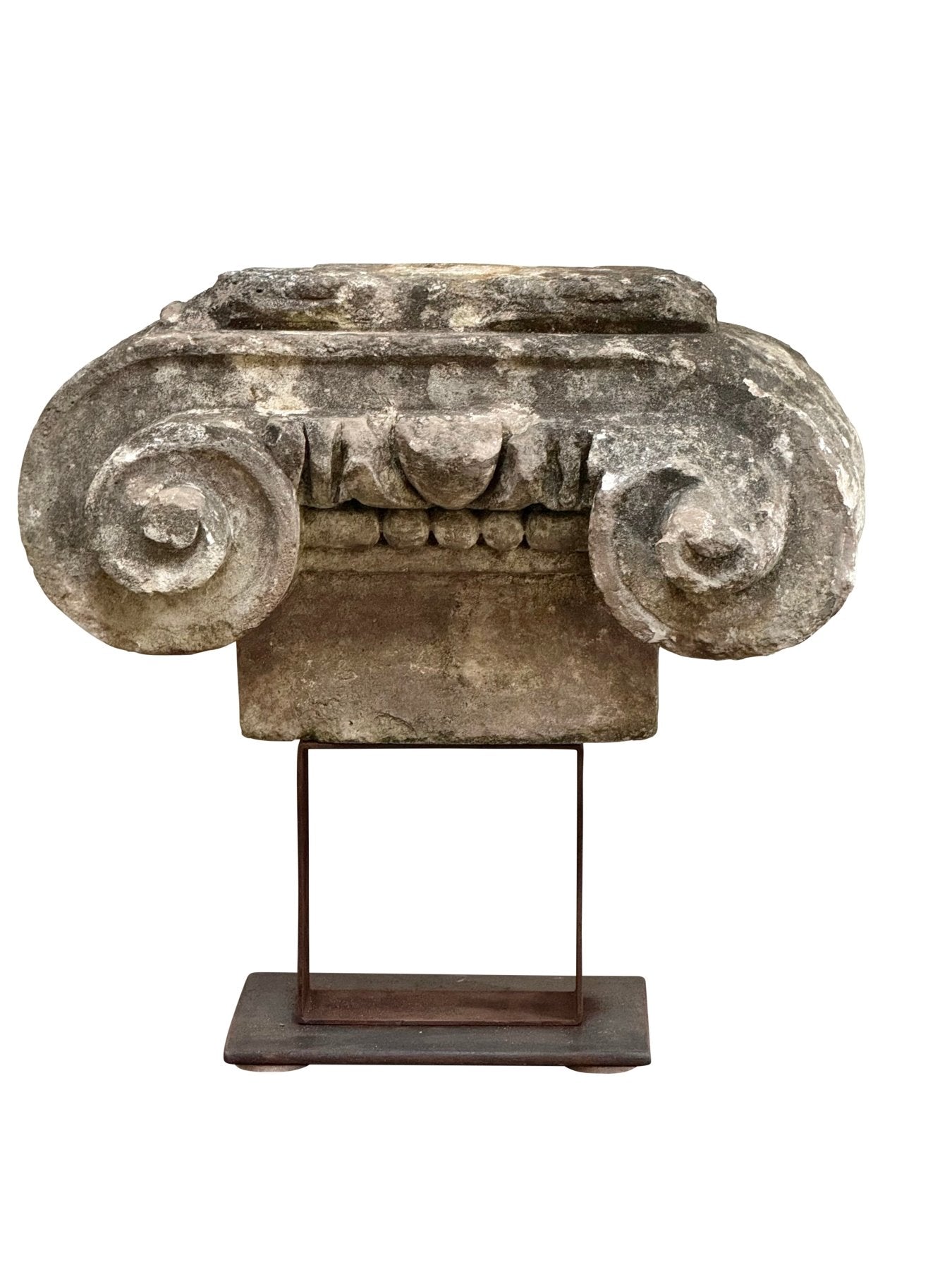 Ancient stone Ionic capital on an iron stand, French